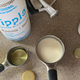 bottle of Ripple alongside measuring cups and a stand mixer base